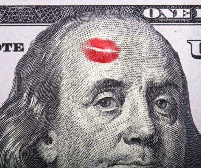 Imprint of the kiss on portrait of Benjamin Franklin on a hundred dollar bill.