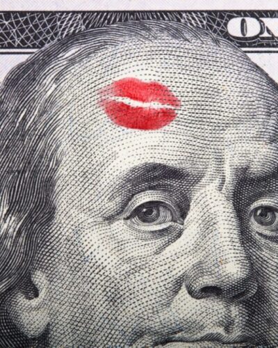 Imprint of the kiss on portrait of Benjamin Franklin on a hundred dollar bill.